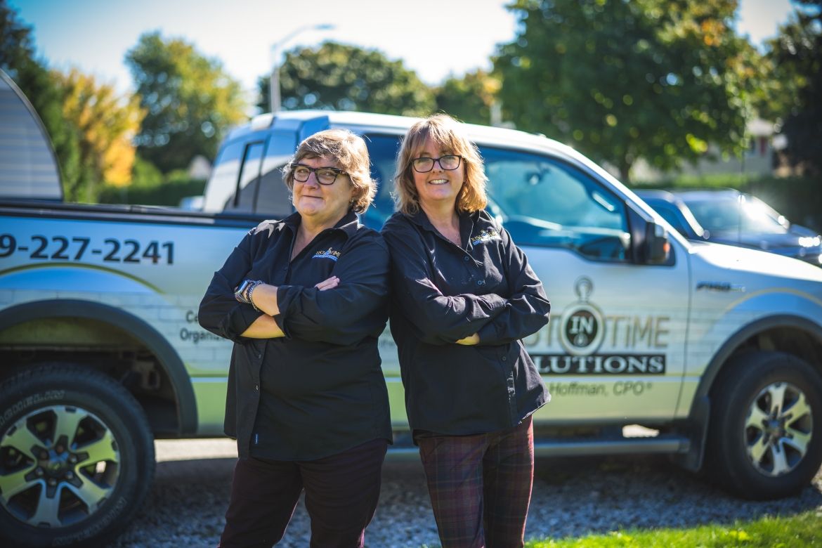 two women standing back to back